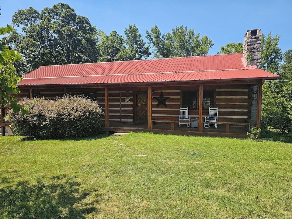 Quaint cabin on beautifully landscaped grounds.