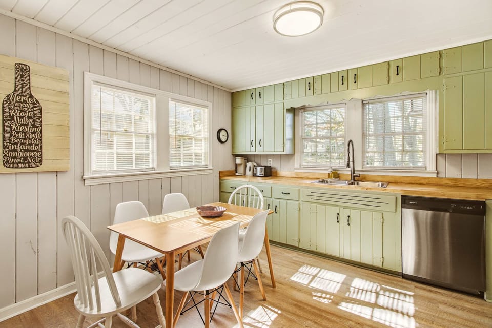 Charming kitchen with vintage cabinets and ample natural light, perfect for cozy meals.