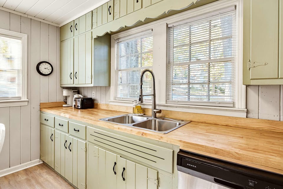 Charming kitchen with vintage cabinets and modern amenities, perfect for preparing meals with ease.