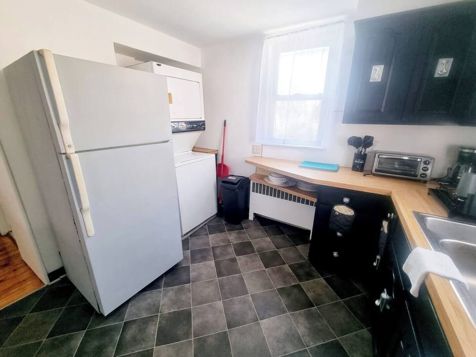 Step into a well-appointed kitchen designed for convenience. It includes a full-sized refrigerator, range, and plenty of counter space for meal prep. You'll find generous storage in the cabinetry, making it easy to keep things organized.
