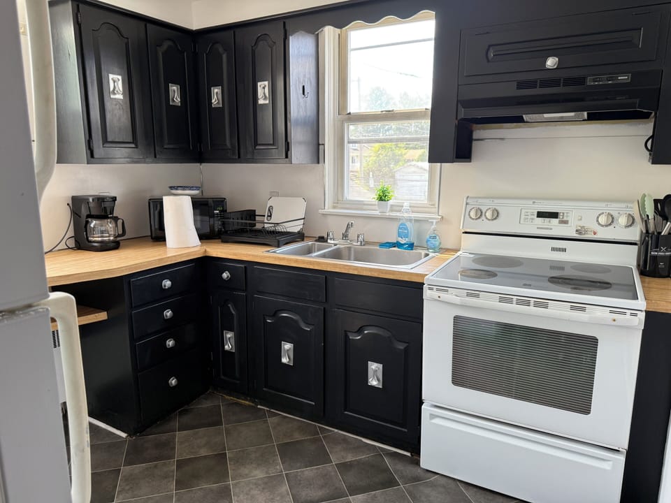 Step into a well-appointed kitchen designed for convenience. It includes a full-sized refrigerator, range, and plenty of counter space for meal prep. You'll find generous storage in the cabinetry, making it easy to keep things organized.
