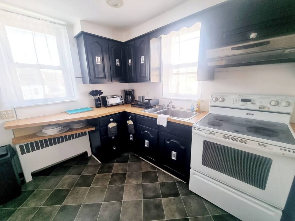 Step into a well-appointed kitchen designed for convenience. It includes a full-sized refrigerator, range, and plenty of counter space for meal prep. You'll find generous storage in the cabinetry, making it easy to keep things organized.
