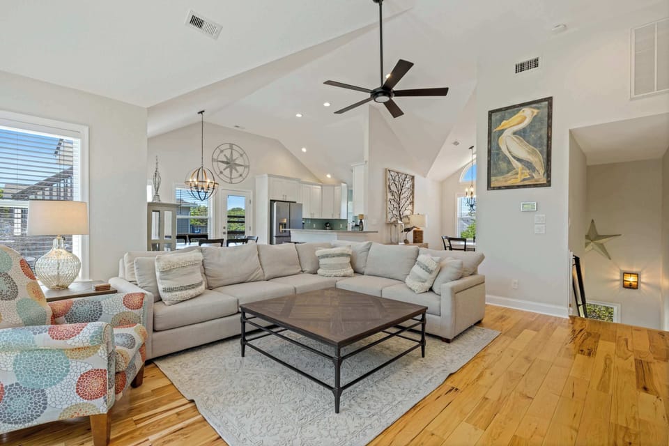 Bright Open Living Room w Vaulted Ceilings, Large Windows, Smart TV and Sectional Couch