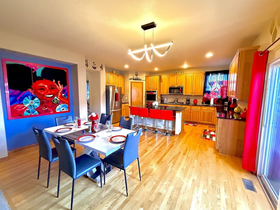 Vast kitchen and dining space overlooking a charming patio, offering a delightful atmosphere for dining and unwinding