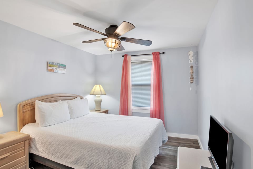 Bedroom 3 sleeps 2 in a queen bed and has a TV