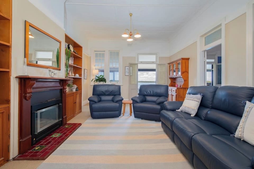 The main lounge area includes a cosy sofa and armchairs to settle into with some TV.