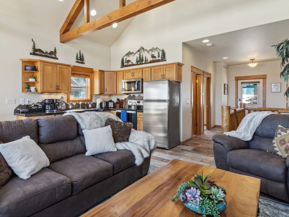 Step into mountain luxury – soaring ceilings, rustic beams, and panoramic views invite you to relax on our comfy Queen pullout sofa.