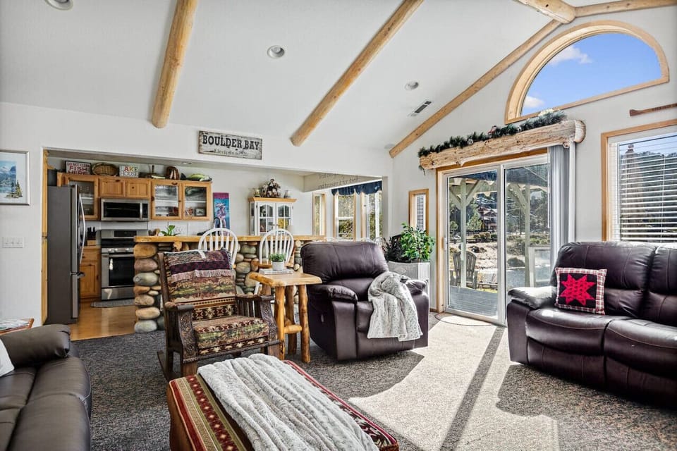 Open concept kitchen and living room space featuring waterfront views.