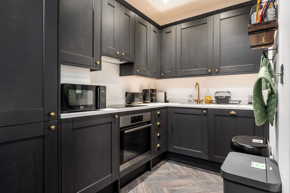 Imagine cooking in this modern kitchen equipped with a premium coffee machine, built-in dishwasher, and integrated washing machine. Complete with full sets of cutlery, plates, bowls, and every amenity you need to cook and entertain.