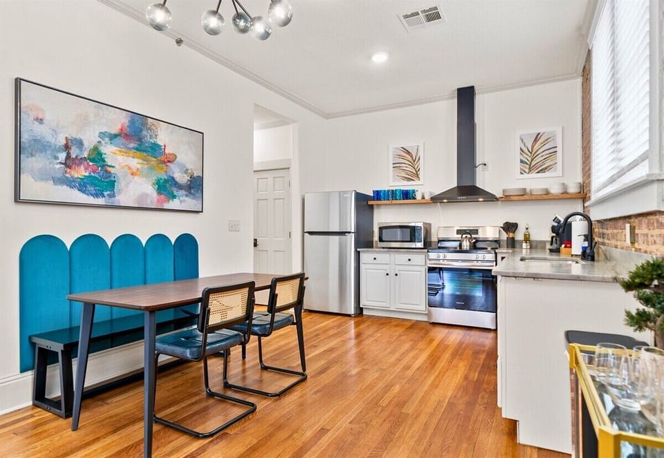 The open layout of the dining and kitchen areas offers a practical and stylish setting for cooking and dining.