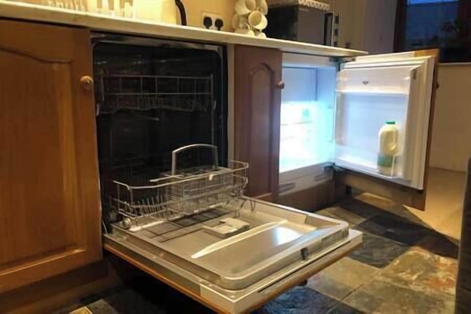 Brand new dishwasher and fridge freezer in kitchen. 