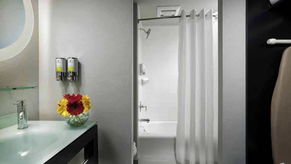 Refresh in a spotless bathroom with bright vanity lighting