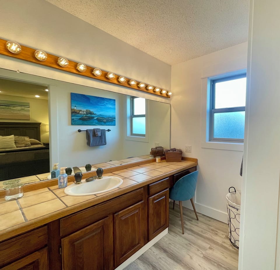 Bathroom, connected to bedroom 1 - lots of counter space and seated vanity area.