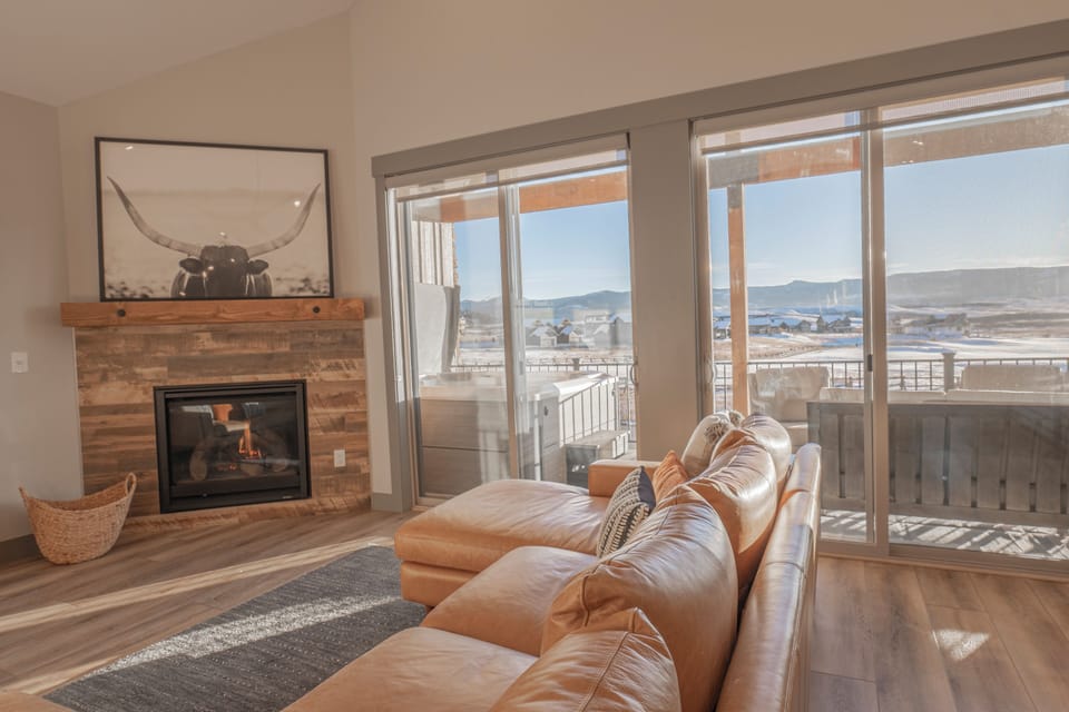 Bright, open living room with breathtaking golf course and mountain views.