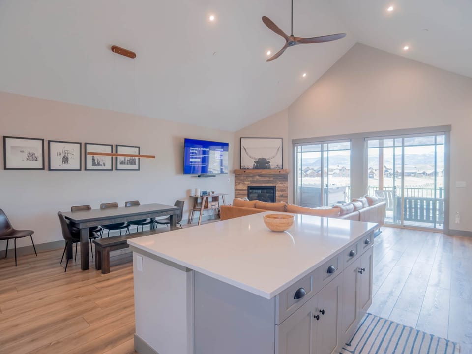 The dining area offers comfortable seating for eight, with three additional seats at the island. 00.