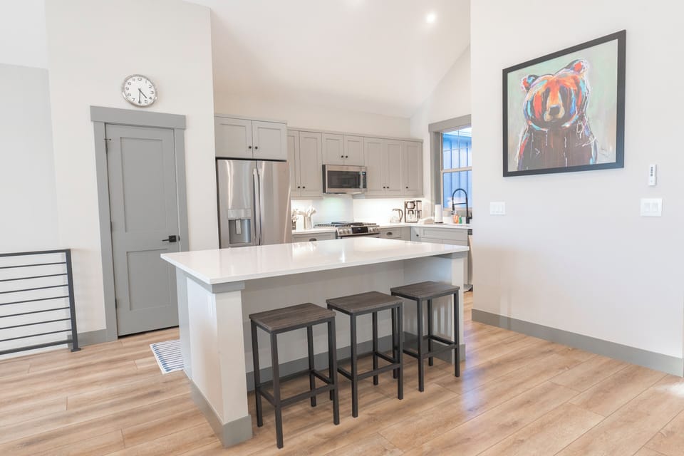 Fully equipped kitchen with modern appliances and a large elegant island.