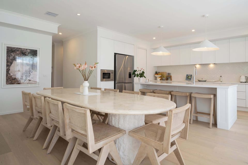 Share unforgettable meals at the exquisite, handcrafted, En Gold oval dining table. 
