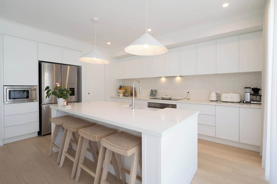 Beautifully designed with a timeless appeal, the kitchen boasts a stunning island bench, a walk-in pantry, and high-end appliances
