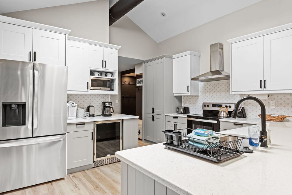 Chef’s Dream Kitchen
A sleek and fully stocked kitchen with high-end appliances, crisp white cabinetry, and a spacious island, making cooking and entertaining effortless.