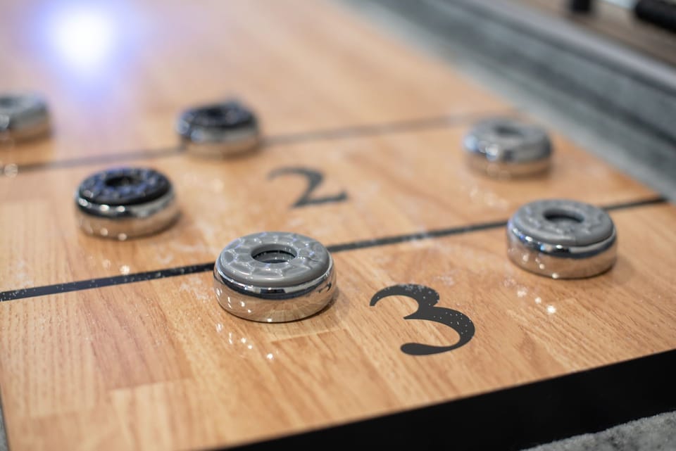 Close-Up of the Shuffleboard Action
Precision meets fun in this classic shuffleboard game. Whether you're a first-timer or a seasoned player, this is the perfect way to keep the good times rolling.