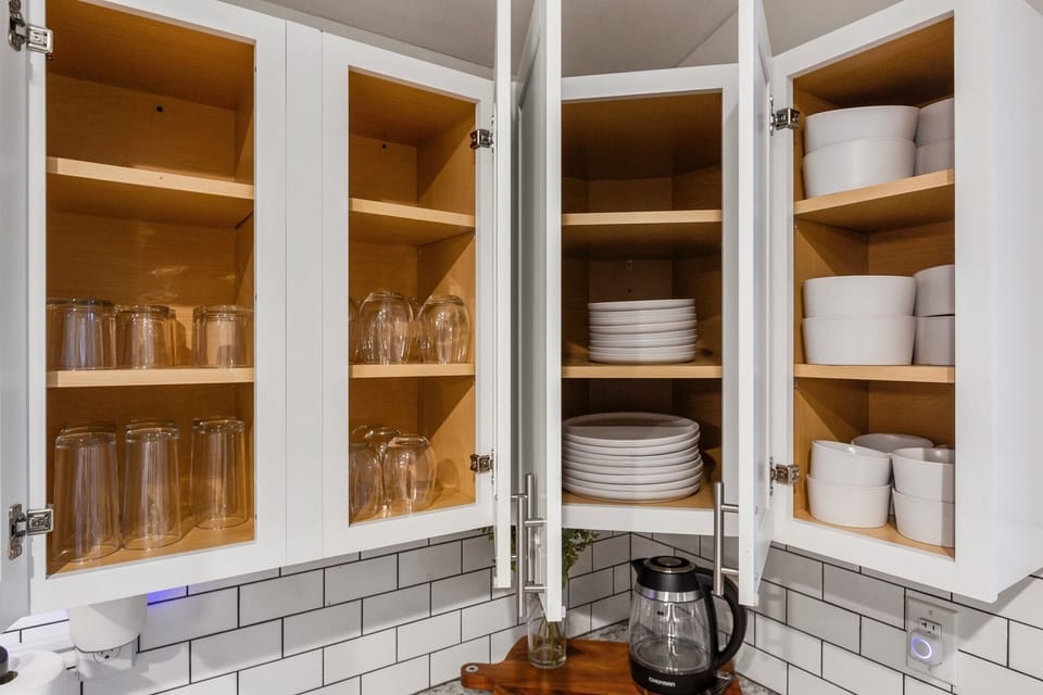 Fully Stocked Kitchen with plenty of dishes, bowls and glassware. 