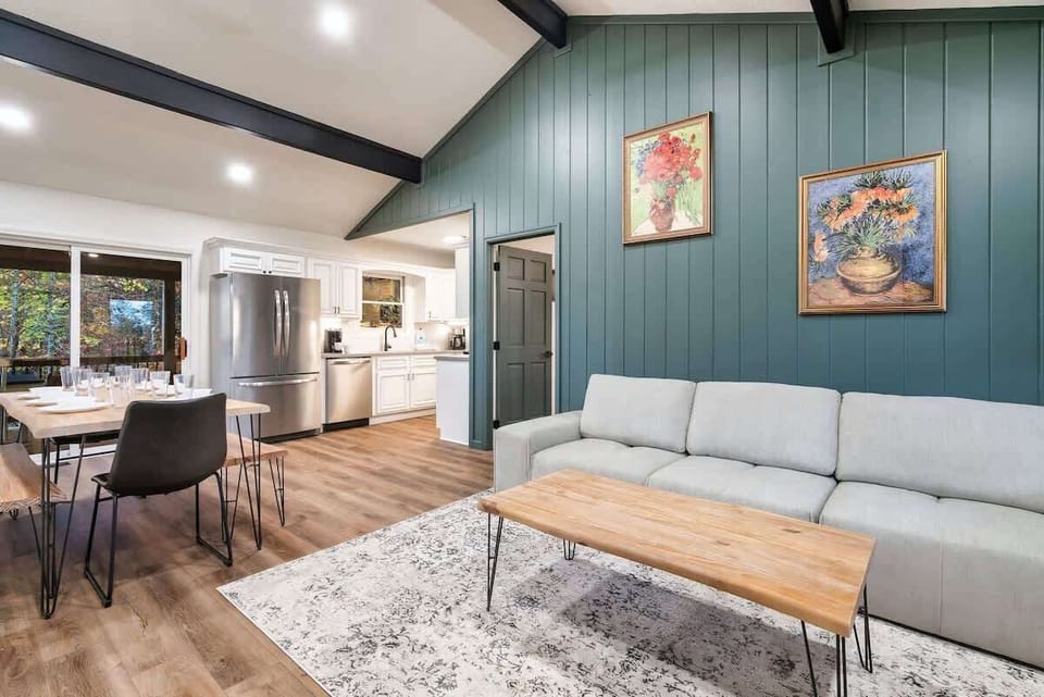Open-concept living area with vaulted ceilings and modern kitchen appliances.
