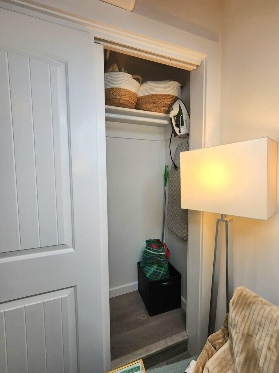 Closet with storage space and iron/board