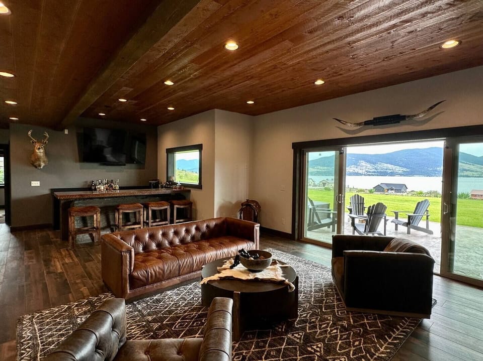 The downstairs den is your spot to unwind - complete with a wood burning fireplace and a four-stool bar with prep sink and cooler.