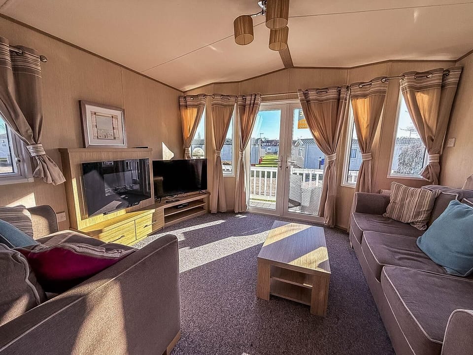Discover the beauty of the Norfolk coast and the excitement of Great Yarmouth while staying in a modern static caravan with a welcoming living area at Hopton Holiday Village.