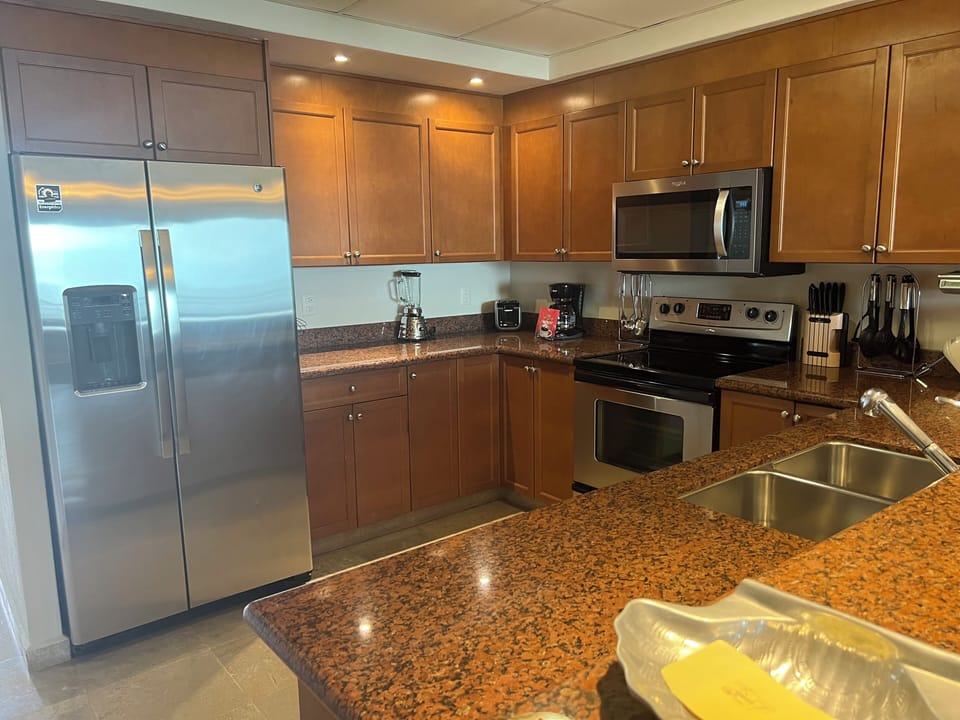 Full kitchen with granite counter top stove, refrigerator, microwave, dishwasher
