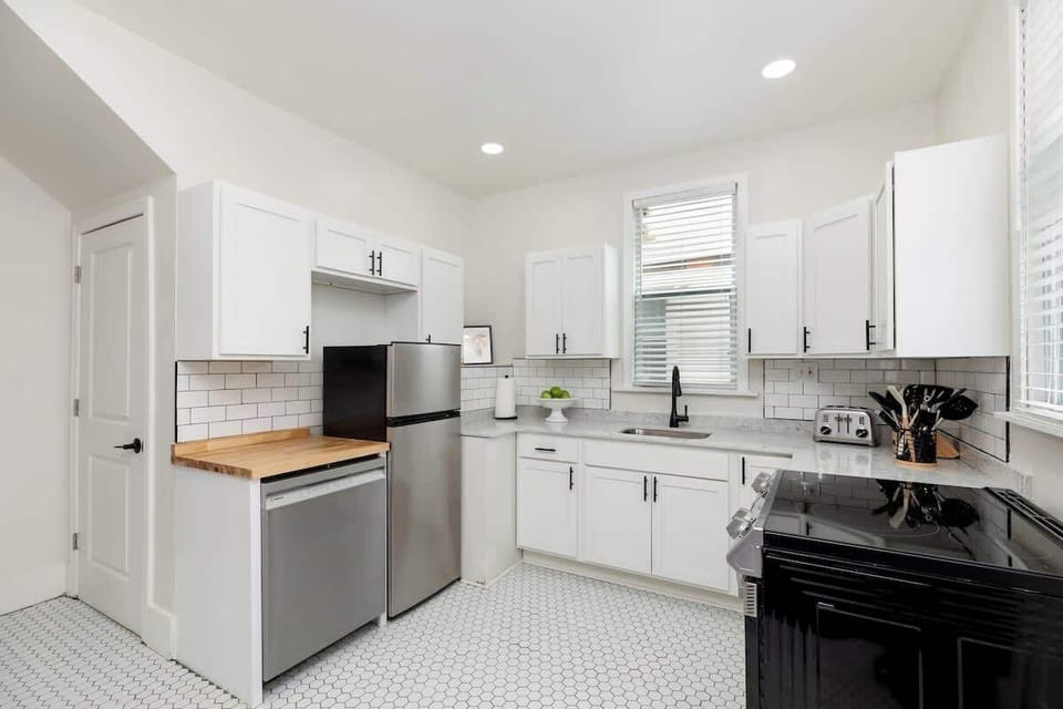 Modern kitchen with stainless appliances.