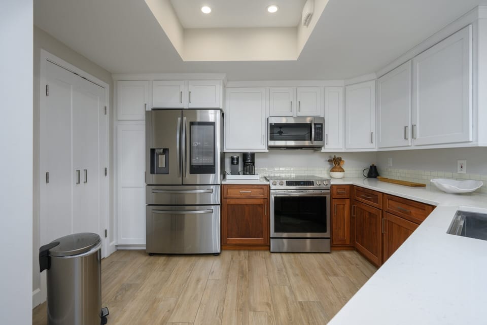 This bright, open kitchen is designed for both function and gathering. Recessed lighting keeps the space airy and inviting.