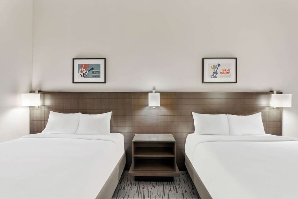 Unwind in crisp double beds under warm, modern lighting.
