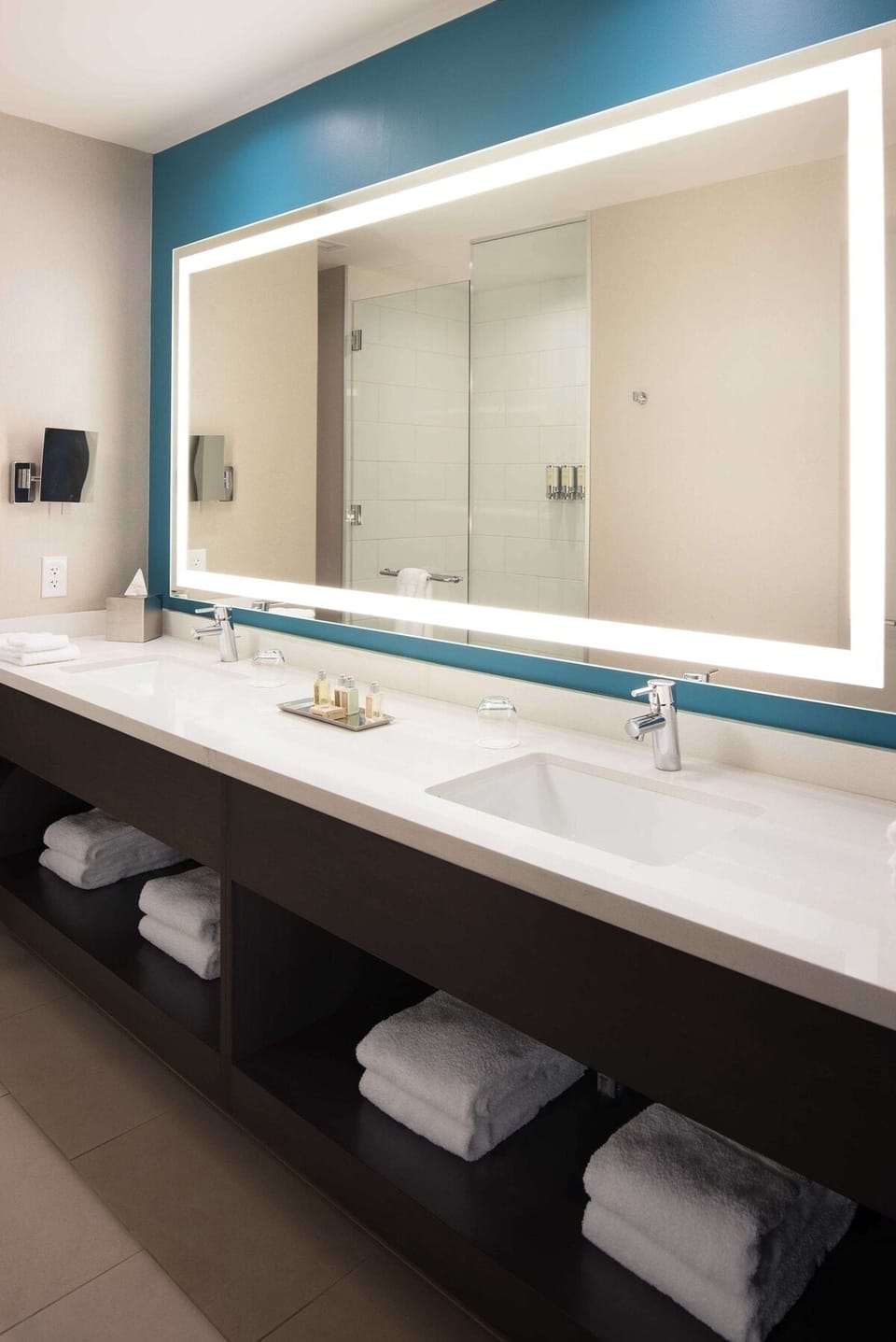 Refresh at a spa-like vanity with glowing mirror lighting.