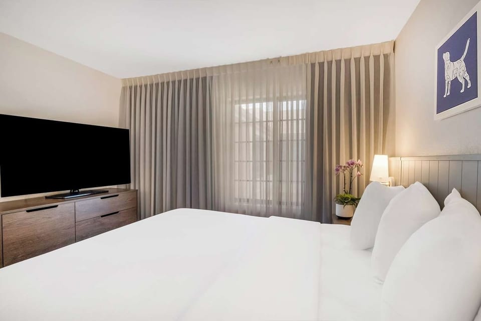 Drift off in a serene bedroom with soft, soothing light.