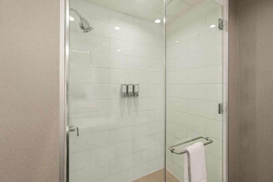 Rinse off in a sleek glass shower with premium fixtures.