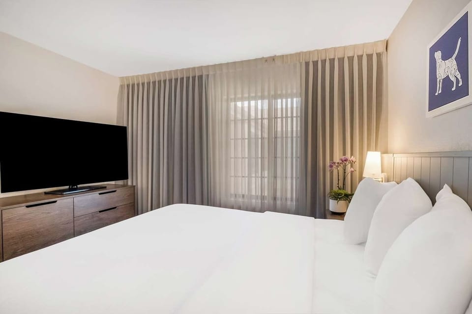 Drift off in a serene bedroom with soft, soothing light.