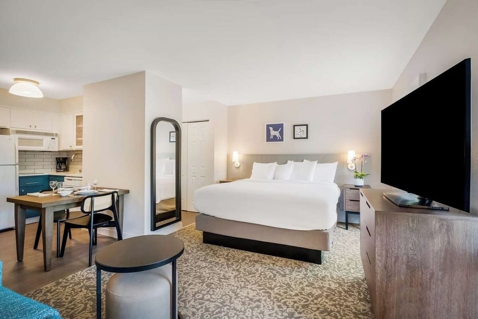 Enjoy a spacious studio feel with bed, dining, and kitchenette.