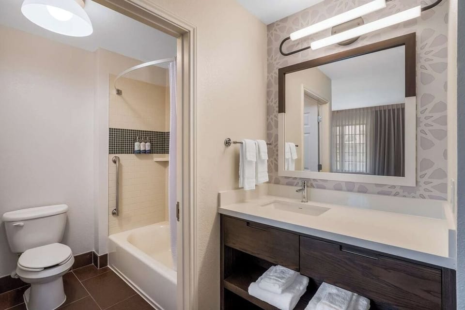 Refresh after adventures with a bright vanity and shower-tub combo.