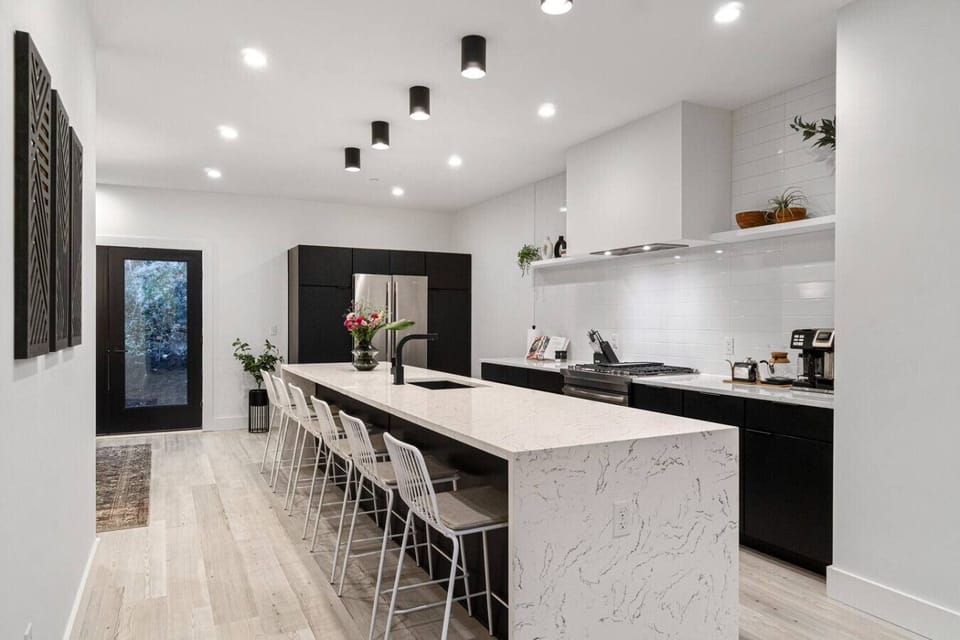 Kitchen island with double waterfall quartz countertops and seating for six