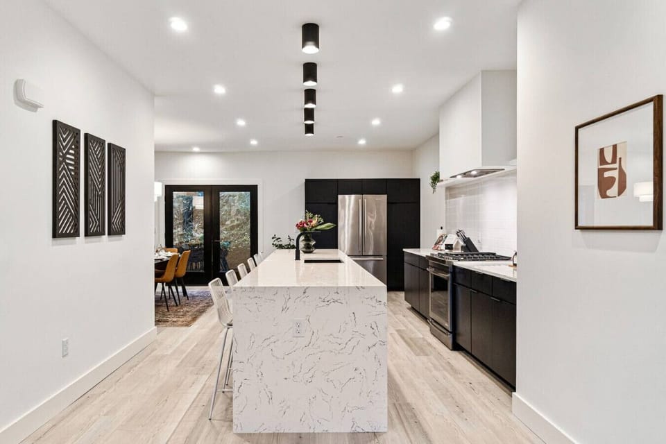 Modern kitchen with waterfall island and seating for groups.