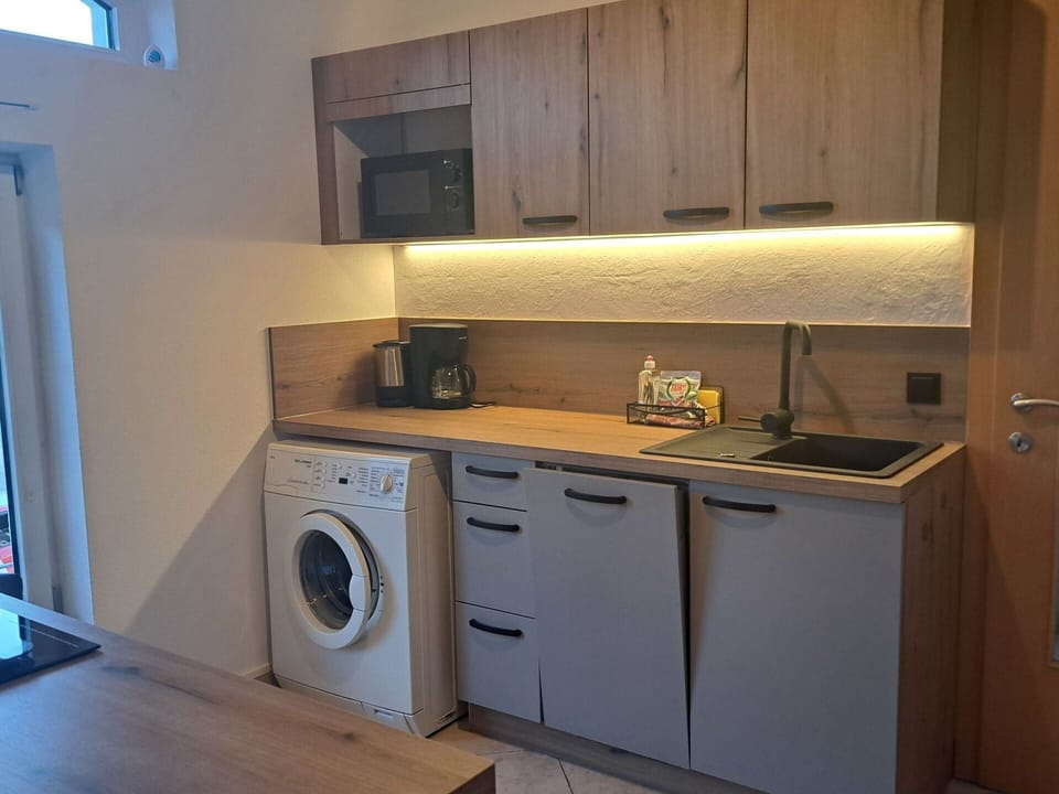 Cabinetry, Property, Laundry Room, Countertop, Kitchen Stove, Kitchen Appliance, Washing Machine, Kitchen, Wood, Kitchen Sink