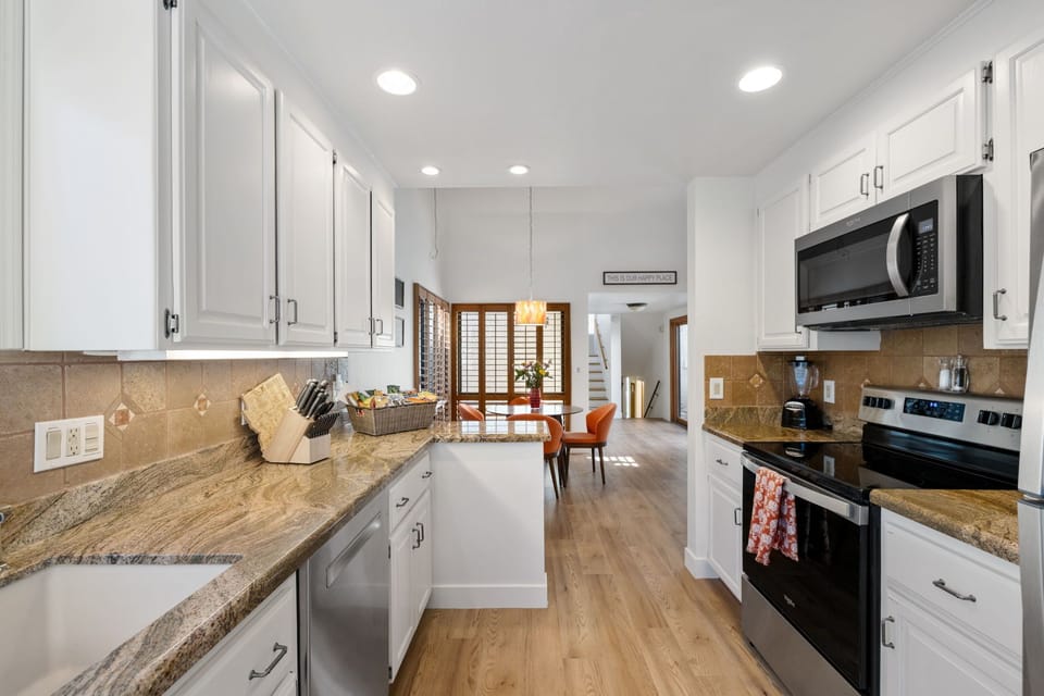 A fully stocked kitchen with modern appliances and plenty of space, perfect for preparing and enjoying home-cooked meals.