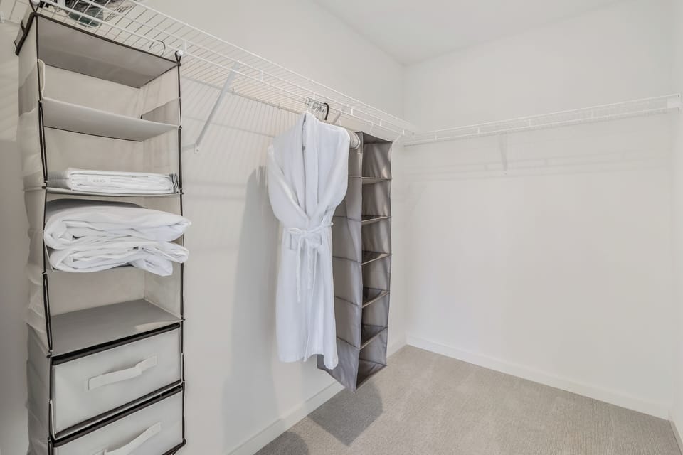 Spacious walk-in closet with plenty of storage, including shelves and hanging space, perfect for an extended stay.