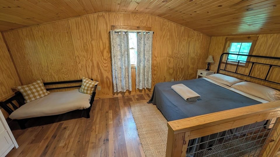 Lofted bedroom space with queen bed.