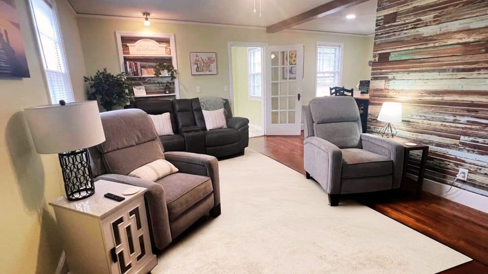 As you enter, a 120-year-old bead board wall greets you, with a recliner set