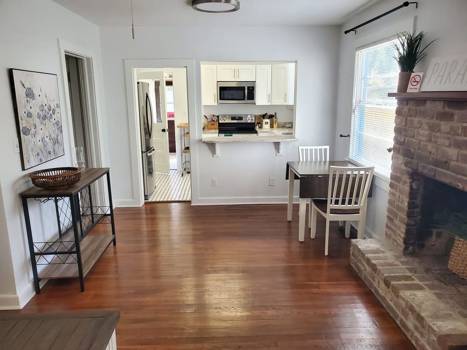 Charming combined dining and kitchen area with a classic fireplace.