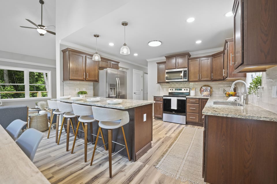 Modern chef’s kitchen with stainless appliances, and spacious island