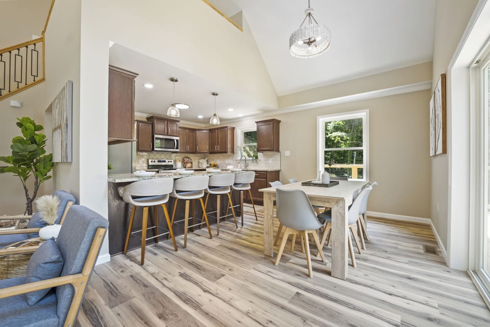Bright open-concept kitchen and dining area with seating for 12 