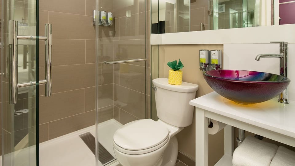 Rinse off in a sleek bath with modern glass shower.